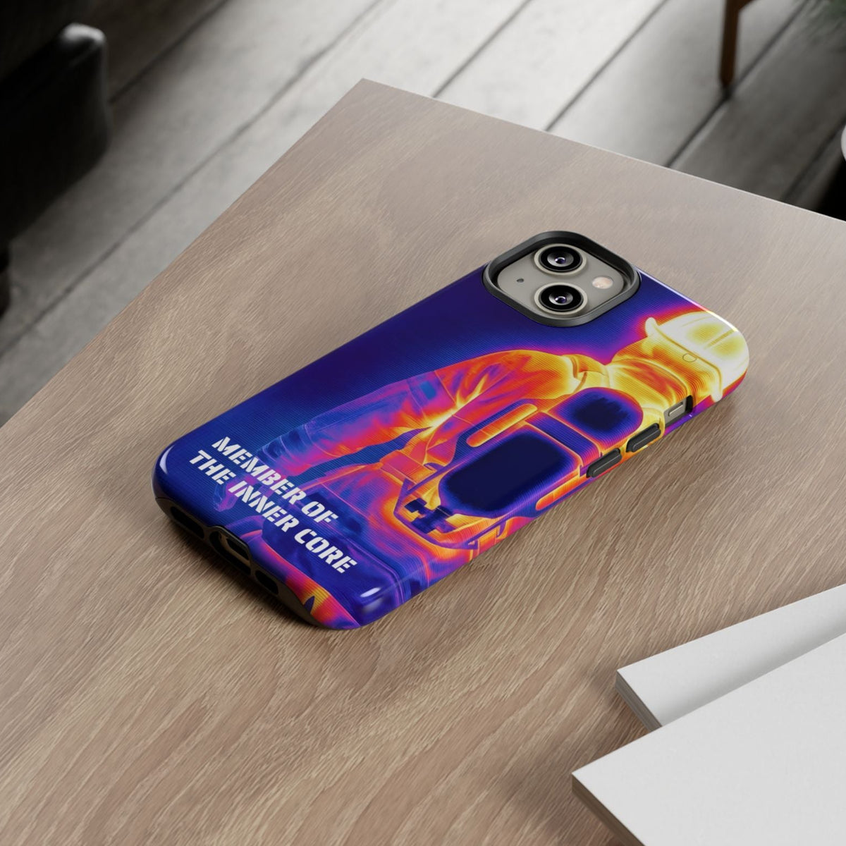 Robustes Feuerwehr iPhone Case im bunten Atemschutz-Wärmebild-Design liegt auf einem hellen Holztisch.