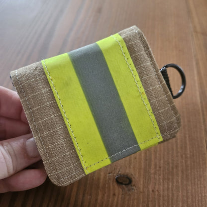 "Feuerwehr Mini-Notfall-Tasche sandfarben kariert mit gelbem Reflexstreifen – in der Hand gehalten, Größenvergleich"

